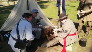 A photo of Civil War Reenactors gathered together.