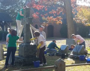 Picture of volunteers cleaning historic gravestones.