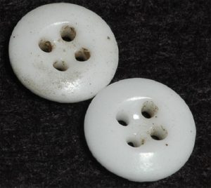 Prosser, four-hole dish type. (Similar to buttons that would have been found in the grave)